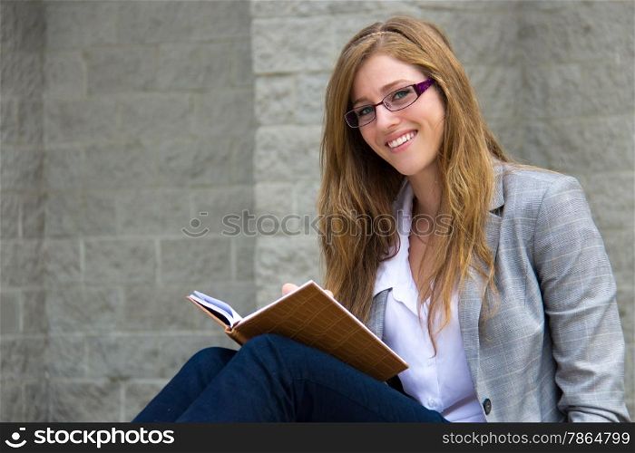 Confident young woman reading her journal