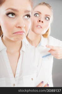 Conflict, bad relationships, friendship difficulties. Two young women having argument. Angry fury girl screaming at her friend or younger sister. Angry fury girl screaming at her friend or younger sister