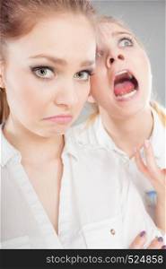 Conflict, bad relationships, friendship difficulties. Two young women having argument. Angry fury girl screaming at her friend or younger sister. Angry fury girl screaming at her friend or younger sister