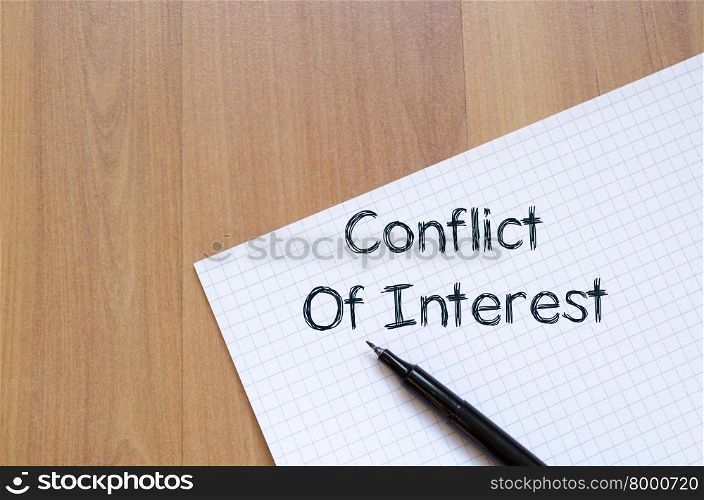Conflict of interest text concept write on notebook with pen