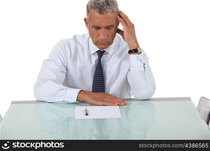 Confused businessman reading document
