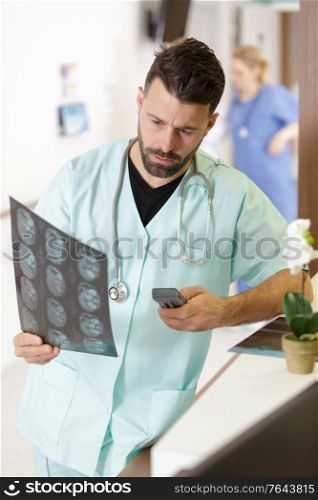 confused doctor looking at magnetic resonance imaging