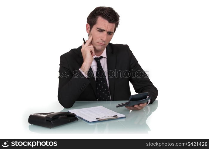 Confused man holding calculator