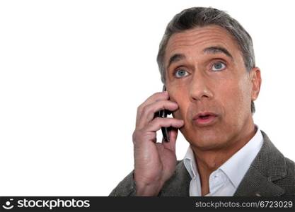 Confused man making telephone call