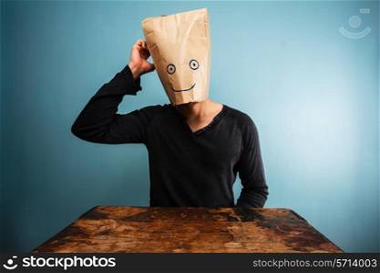 Confused man with paper bag over his head