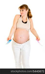 Confused pregnant woman holding color paint samples isolated on white&#xA;