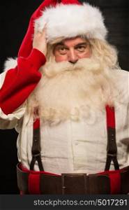 Confused Santa Clause portrait against dark background