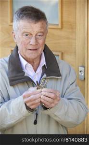 Confused Senior Man Trying To Find Door Key