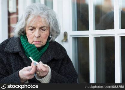 Confused Senior Woman Trying To Find Door Key