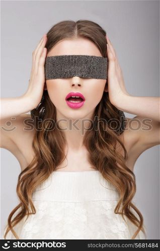 Confusion. Woman holding Headband on her Head