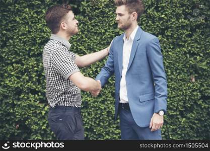 Congratulation to collaboration partner after sign on contract. Diverse Businessman shake hands together with businessman to introduce meeting. Trustworthy student friends meeting. Business Concept