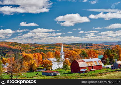 Congregational Church and farm with red barn at sunny autumn day in Peacham, Vermont, USA