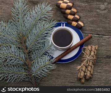 coniferous branch, coffee and cookies top view