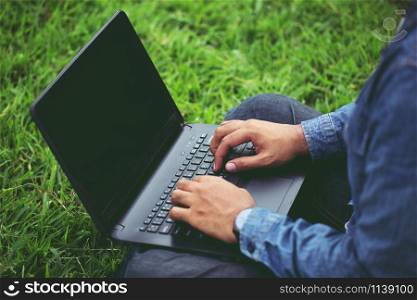 Connect online business using laptop. or Sitting work on the parks.