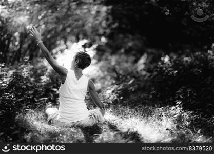 Connecting with Nature, Mindfulness Meditation. A mindful woman meditating, surrounded by beautiful nature. Connecting with Nature, Mindfulness Meditation
