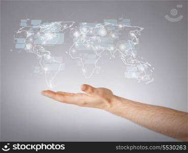 connection and future technology concept - closeup of mans hand showing world map
