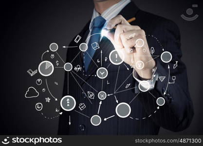 Connection and interaction concept. Chest view of businessman drawing connection lines on screen