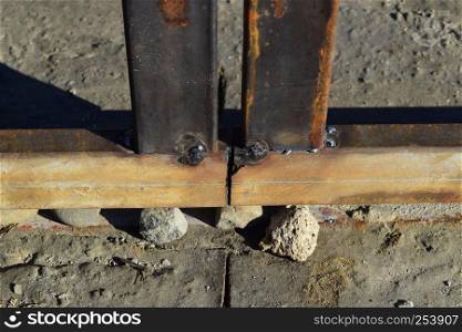 Connection by welding of metal square pipes. Welding seam.. Connection by welding of metal square pipes