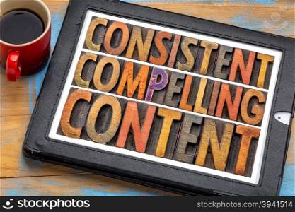 consistent, compelling content - recommendation for bloging and social media marketing - a word abstract in vintage letterpress wood type on a digital tablet with a cup of coffee