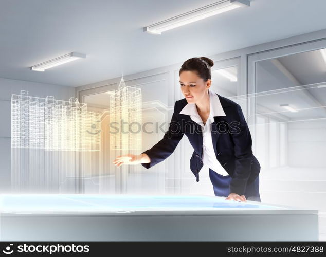 Construction and innovation technologies. Image of young businesswoman clicking icon on high-tech picture