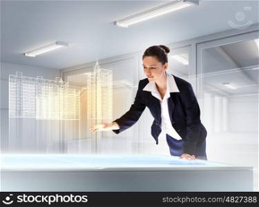 Construction and innovation technologies. Image of young businesswoman clicking icon on high-tech picture