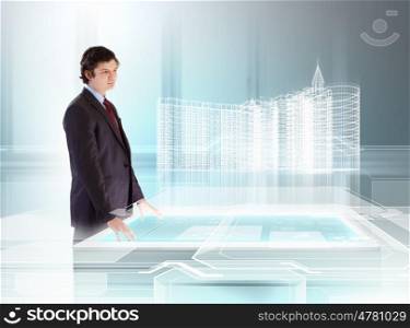 Construction and innovation technologies. young businessman looking at high-tech image of building model