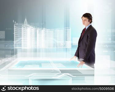 Construction and innovation technologies. young businessman looking at high-tech image of building model