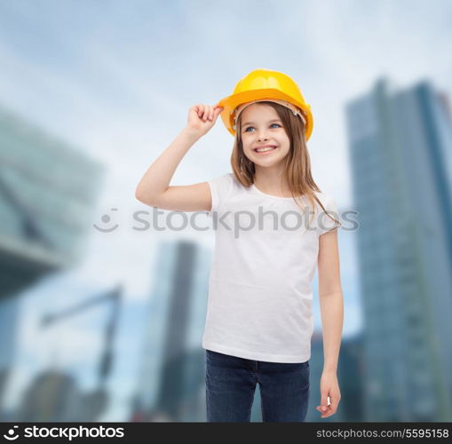 construction and people concept - smiling little girl in protective helmet looking up