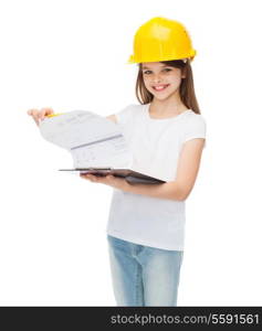 construction and people concept - smiling little girl in protective helmet with clipboard