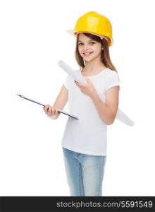 construction and people concept - smiling little girl in protective helmet with clipboard and blueprint