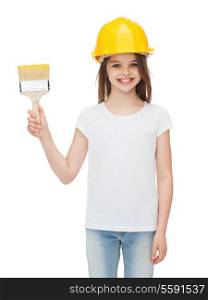 construction and people concept - smiling little girl in protective helmet with paint brush