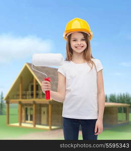 construction and people concept - smiling little girl in protective helmet with paint roller