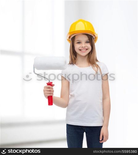 construction and people concept - smiling little girl in protective helmet with paint roller