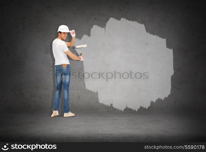 construction and renovation concept - handsome painter in helmet from the back
