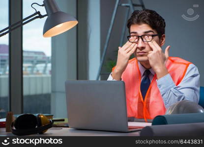 Construction architect working on drawings late at night