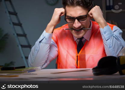 Construction architect working on drawings late at night