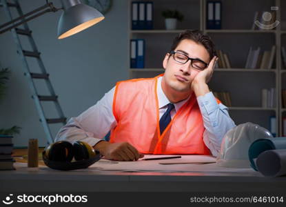 Construction architect working on drawings late at night