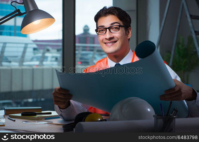 Construction architect working on drawings late at night