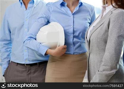 construction, building and people concept - close up of business team with hard hat or safety helmet. close up of business team with hard hat