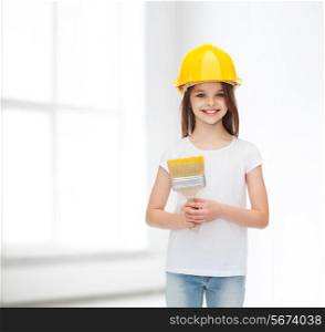 construction, building, childhood and people concept - smiling little girl in protective helmet with paint brush over white room background