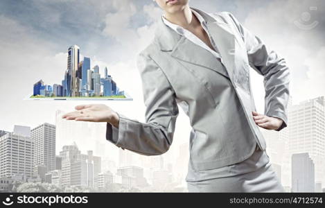 Construction business. Businesswoman in suit holding tablet pc on palm