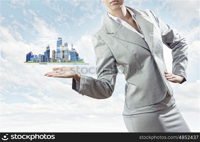 Construction business. Businesswoman in suit holding tablet pc on palm