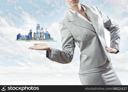 Construction business. Businesswoman in suit holding tablet pc on palm