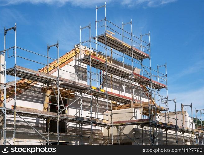 Construction business, framing of multi-family house against blue sky