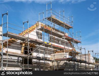 Construction business, framing of multi-family house against blue sky