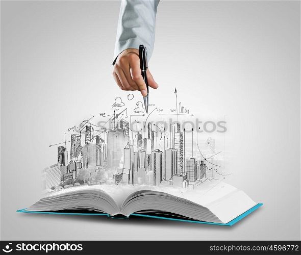 Construction business. Opened book and hand drawing building sketches