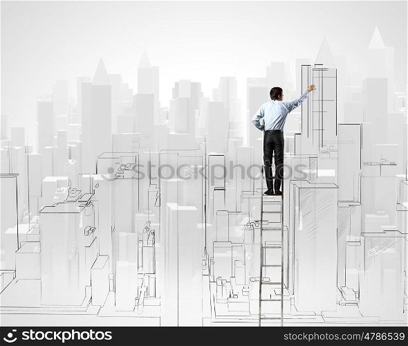 Construction concept. Back view of businessman standing on ladder and drawing buildings