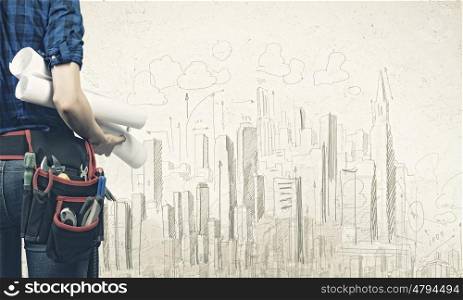 Construction concept. Close up of woman mechanic with project in hand against city background
