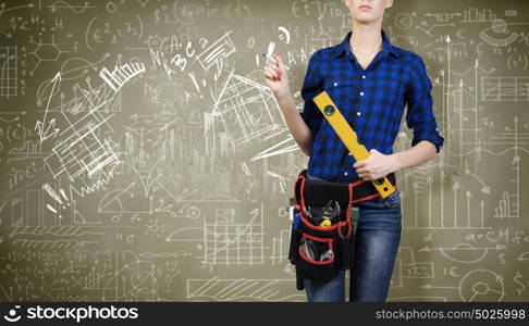 Construction concept. Close up of woman mechanic with ruler in hand against city background