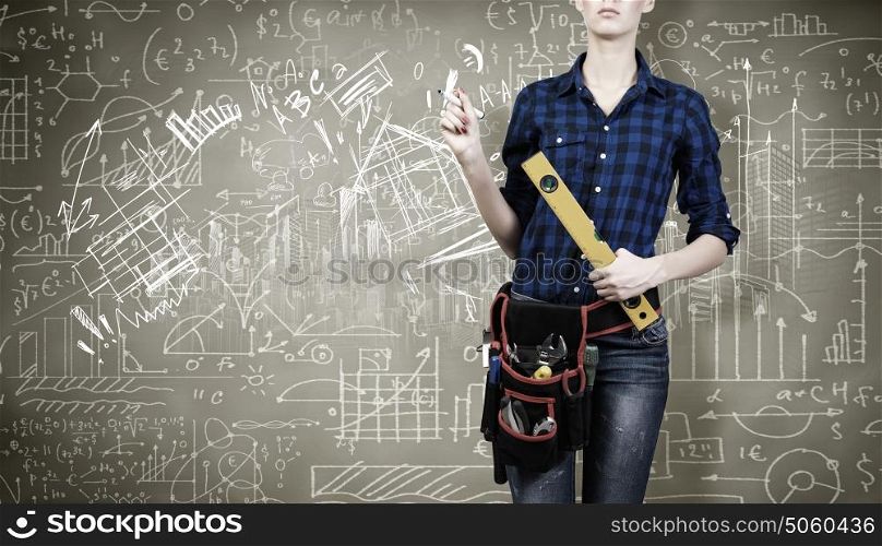 Construction concept. Close up of woman mechanic with ruler in hand against city background